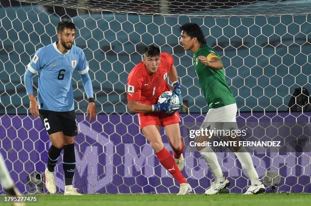 Uruguay's goalkeeper Sergio Rochet grabs the ball next to Uruguay's midfielder Rodrigo Bentancur and Bolivia's forward Marcelo Martins during the...