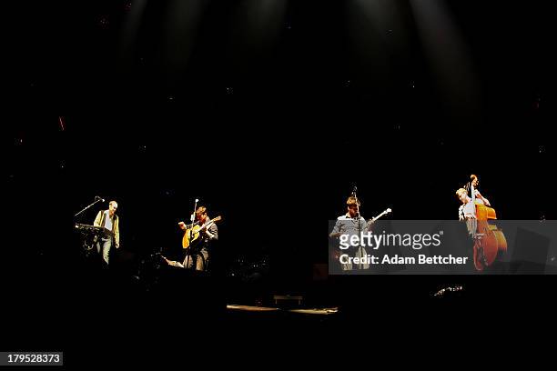 Ben Lovett, Marcus Mumford, Winston Marshall and Ted Dwayne of the band Mumford & Sons perform on September 4, 2013 at The Xcel Energy Center in St....