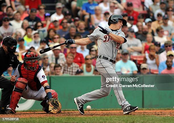 Andy Dirks of the Detroit Tigers swings at a pitch in the seventh inning against the Boston Red Sox at Fenway Park on September 2, 2013 in Boston,...