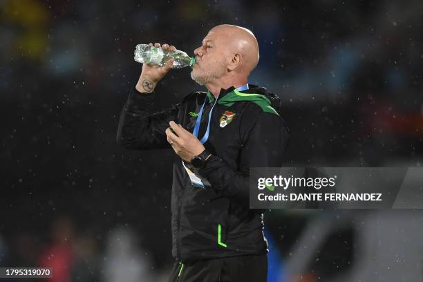 Bolivia's Brazilian coach Antonio Zago drinks water during the 2026 FIFA World Cup South American qualification football match between Uruguay and...