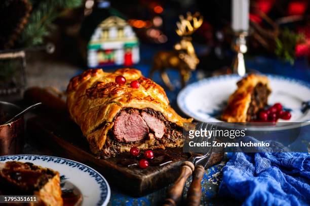 beef wellingon  on a festive, new year's table - beef wellington foto e immagini stock