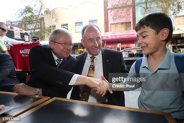 Australian Prime Minister, Kevin Rudd meets voters, with Immigration Minister Tony Burke and Labor MP John Murphy on September 5, 2013 in Sydney,...