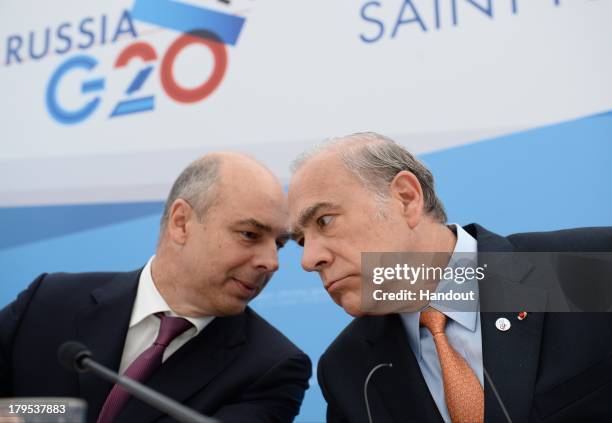 In this handout image provided by Host Photo Agency, Anton Siluanov, Finance Minister of the Russian Federation, and Jose Angel Gurria, Secretary...