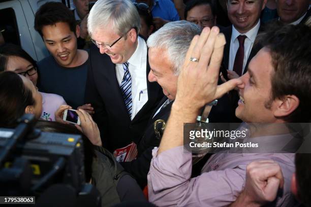 Australian Prime Minister, Kevin Rudd poses for photos with voters, as satirist Andrew Hansen tries to shake Kevin Rudd's hand, in Western Sydney on...