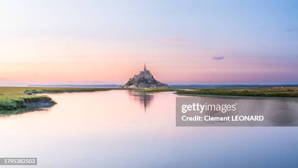 wide angle view of the mont saint-michel (mont-saint-michel) reflecting in the sea at sunset during high tide, manche, normandie (normandy), western france. - equinox stock-fotos und bilder