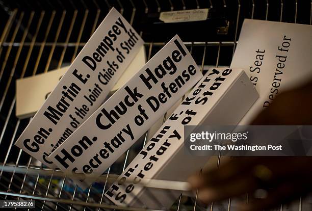 Senate Foreign Relations committee staff prep the hearing room with name plates of Secretary of State John Kerry, Secretary of Defense Chuck Hagel,...