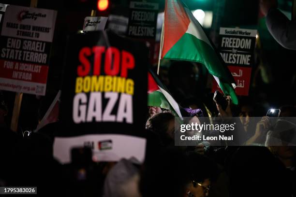 Protestors chant and wave flags as they call for the Government to back a vote on a ceasefire in Israel, during a demonstration at Parliament Square...