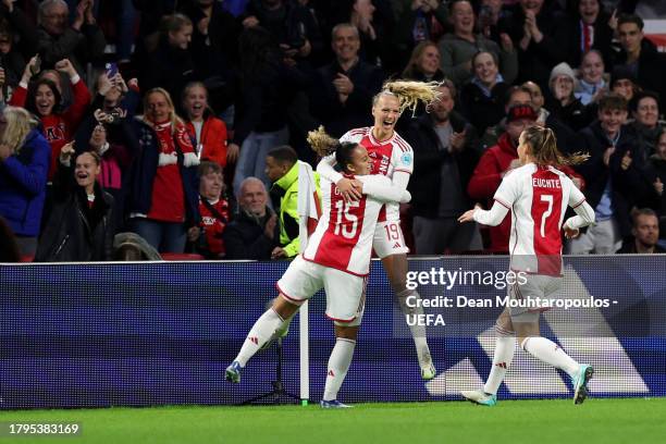 Tiny Hoekstra of Ajax celebrates with teammates Chasity Grant and Romee Leuchter after scoring the team's first goal during the UEFA Women's...