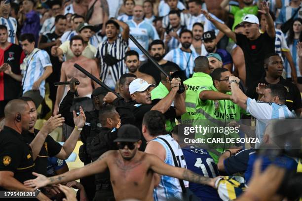 Fans of Argentina clash with Brazilian police before the start of the 2026 FIFA World Cup South American qualification football match between Brazil...