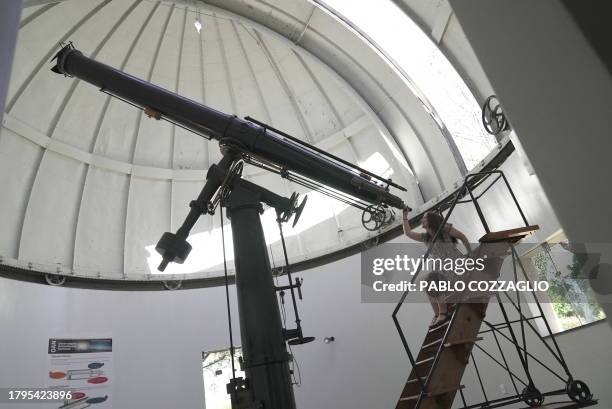 Chilean astronomer Teresa Paneque looks through a telescope at the National Astronomical Observatory of Chile in Santiago on November 16, 2023....