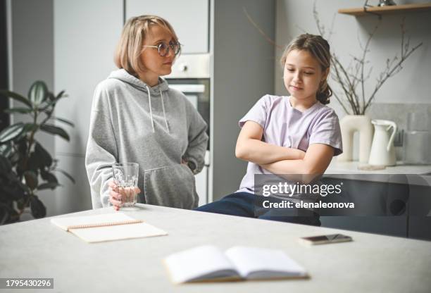 mother and daughter doing homework - anti quarantine protest stock pictures, royalty-free photos & images