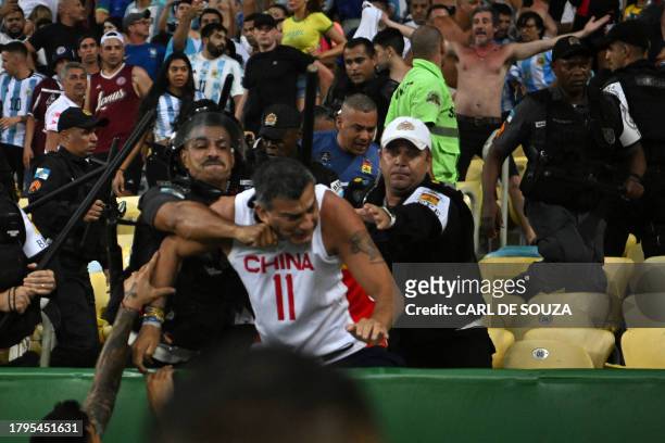 Fans of Argentina clash with Brazilian police before the start of the 2026 FIFA World Cup South American qualification football match between Brazil...