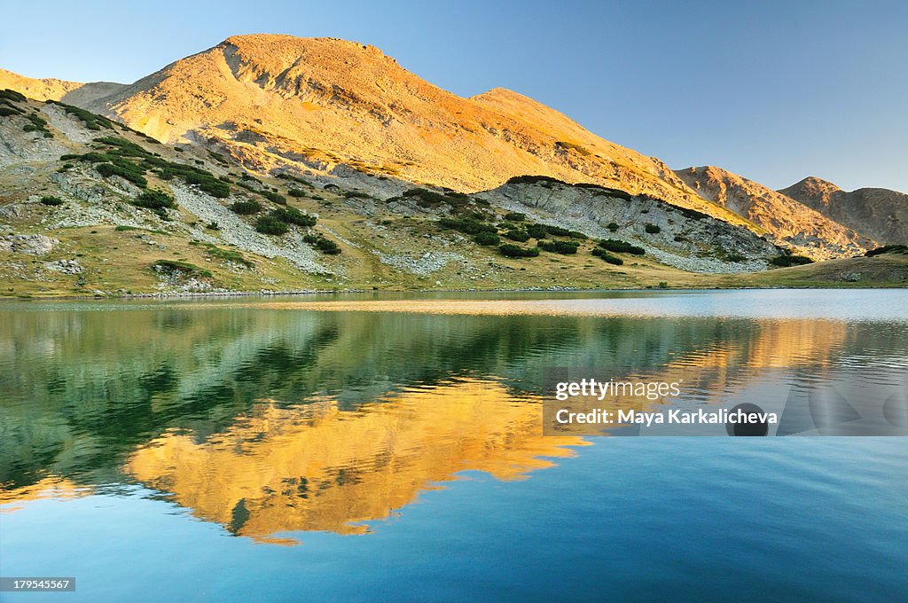 Alpenglow reflecting on mountain lake