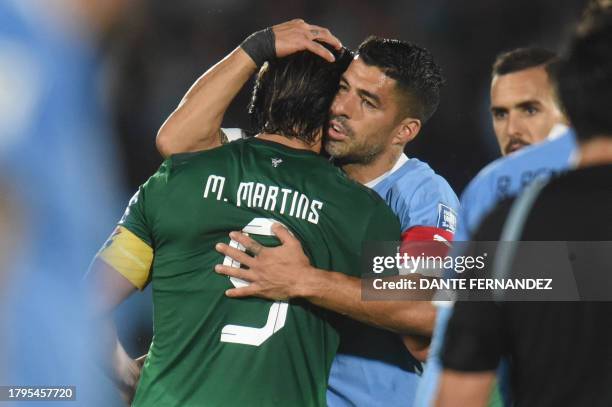Bolivia's forward Marcelo Martins is greeted by Uruguay's forward Luis Suarez as he leaves the field during the 2026 FIFA World Cup South American...