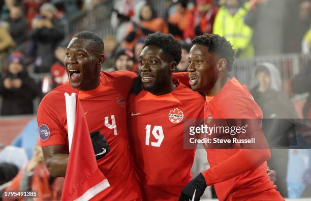 Canada Alphonso Davies celebrates after scoring with Canada Kamal Miller and Canada forward Jonathan David following as Canada plays Jamaica in the...