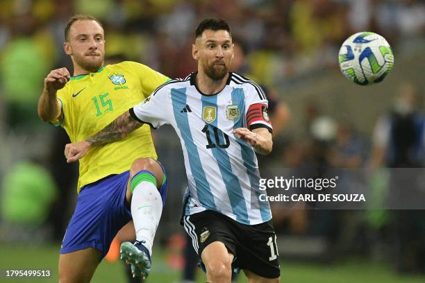 Brazil's defender Carlos Augusto and Argentina's forward Lionel Messi fight for the ball during the 2026 FIFA World Cup South American qualification...