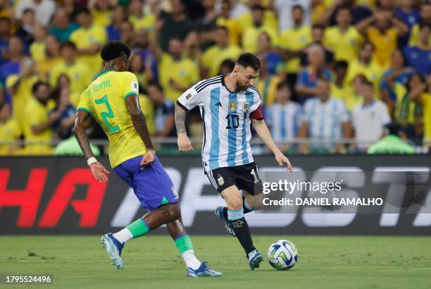 Brazil's forward Emerson fights for the ball with Argentina's forward Lionel Messi during the 2026 FIFA World Cup South American qualification...