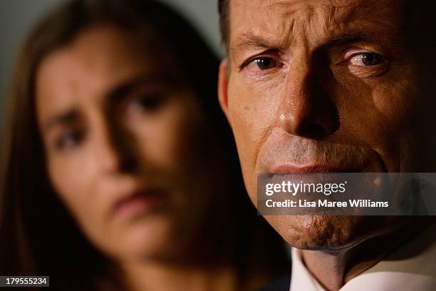 Opposition Leader, Tony Abbott addresses the media as his daughter Frances Abbott looks on at the Rosella Factory on September 5, 2013 in Dandenong,...