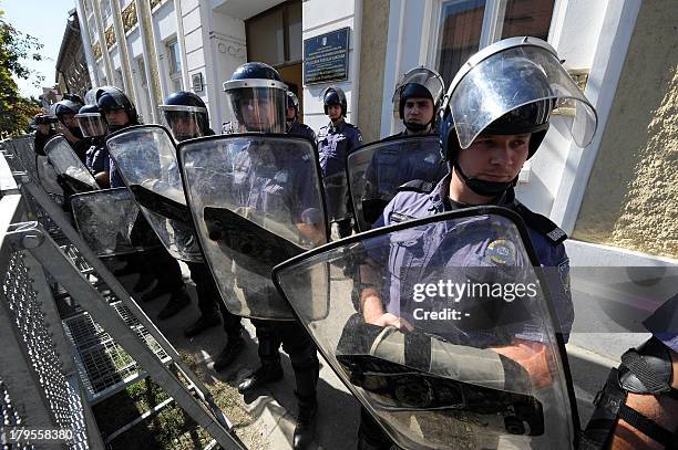 Police guard on September 4, 2013 government buildings in Vukovar as some 500 people protest for the third consecutive day against signs partly...