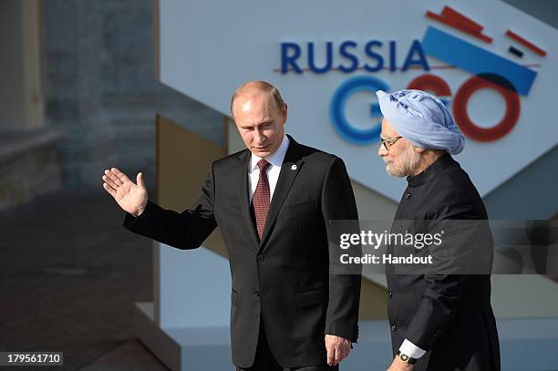 In this handout image provided by Host Photo Agency, Russian President Vladimir Putin, left, and Prime Minister of the Republic of India Manmohan...
