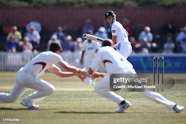 Benjamin Slater of Derbyshire looks back as he edges a delivery from Alfonso Thomas of Somerset which is fielded by Marcus Trescothick and Nick...