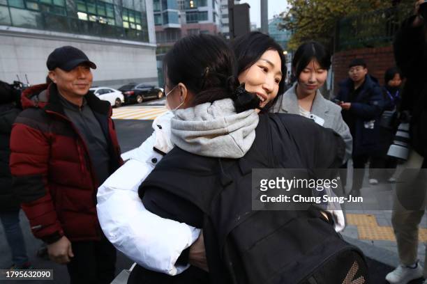 Mother hugs her daughter before she takes the College Scholastic Ability Test in front of the main gate of an examination school on November 16, 2023...