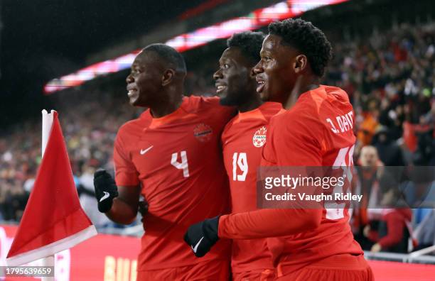 Alphonso Davies of Canada celebrates a goal with Kamal Miller and Jonathan David during a CONCACAF Nations League match against Jamaica at BMO Field...