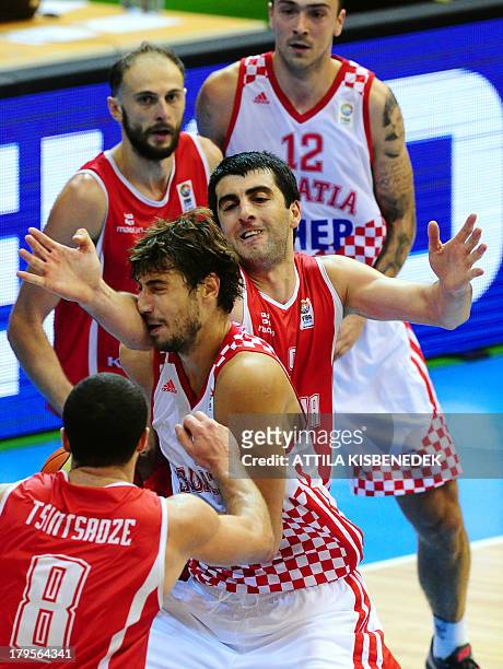 Croatia's Ante Tomic fights for the ball with with Georgia's Giorgi Shermadini , George Tsintsadze and Viktor Sanikidze as Croatia's Damir Markota...