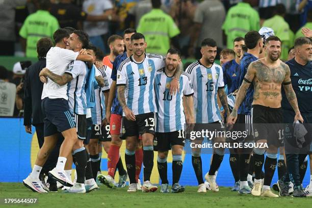 Argentina's forward Lionel Messi and defender Cristian Romero celebrat their victory at the end of the 2026 FIFA World Cup South American...