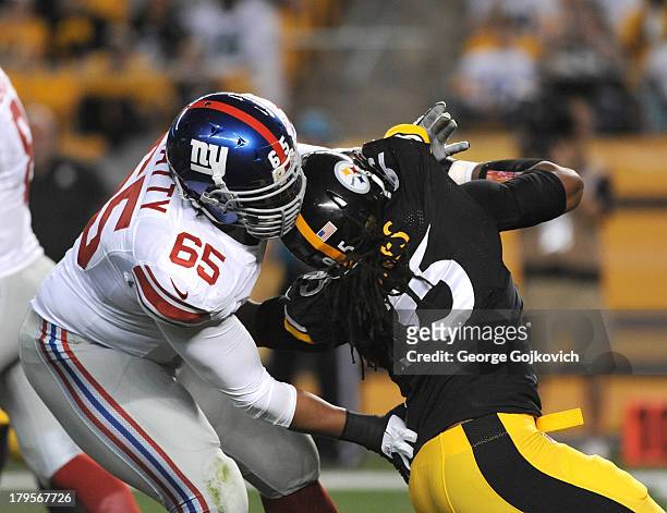 Offensive lineman Will Beatty of the New York Giants blocks linebacker Jarvis Jones of the Pittsburgh Steelers during a preseason game at Heinz Field...