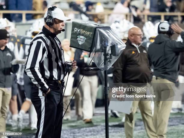 Mid-Atlantic Conference official uses the DV Sport Replay to confirm a play during the college football game between the Ball State Cardinals and...