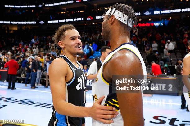 Trae Young of the Atlanta Hawks speaks with Buddy Hield of the Indiana Pacers following the Pacers 157-152 victory over the Hawks in an NBA In-Season...