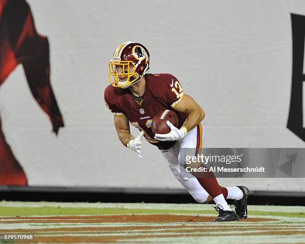 Wide receiver Nick Williams of the Washington Redskins returns a kick against the Tampa Bay Buccaneers August 29, 2013 at Raymond James Stadium in...