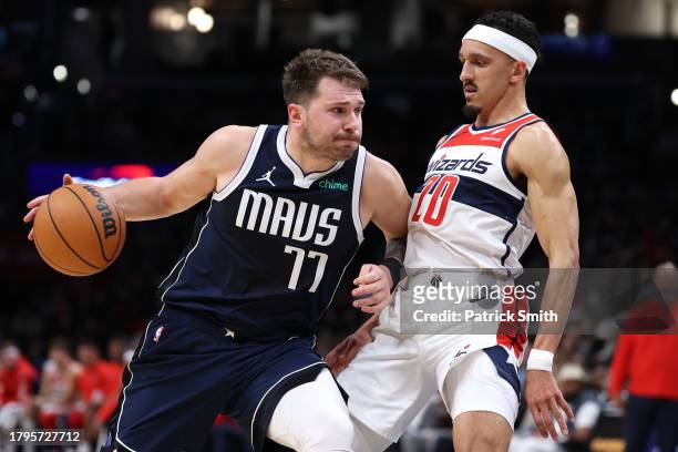 Luka Doncic of the Dallas Mavericks dribbles in front of Landry Shamet of the Washington Wizards during the first half at Capital One Arena on...