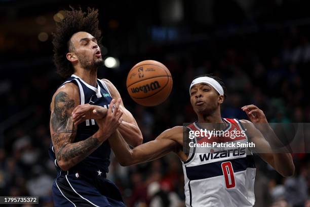 Dereck Lively II of the Dallas Mavericks has the ball stolen by Bilal Coulibaly of the Washington Wizards during the first half at Capital One Arena...