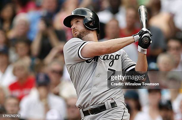 Jeff Keppinger of the Chicago White Sox follows through against the Boston Red Sox during the fourth inning at Fenway Park on September 1, 2013 in...