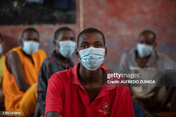 Inmates diagnosed with Tuberculosis look on at an isolated cell in the maximum security prison of Maputo on November 6, 2023. A large pilot of an...