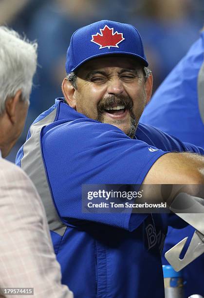 Special coach Sal Fasano of the Toronto Blue Jays talks to former catcher Buck Martinez during batting practice before an MLB game against the Kansas...