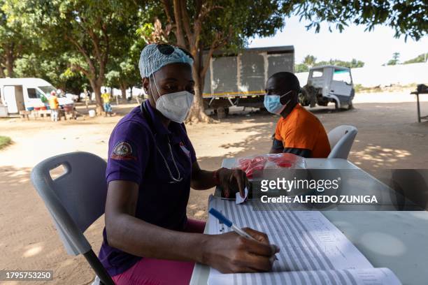 Medical staff member performs a medical checkup on an inmate at the general prison in Maputo on November 6, 2023. A large pilot of an artificial...
