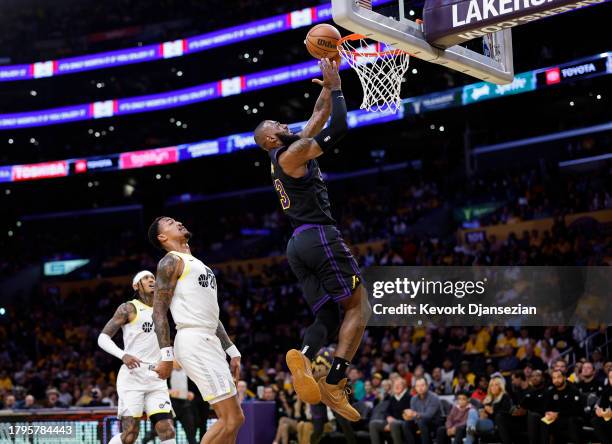 LeBron James of the Los Angeles Lakers scores a basket on layup against John Collins of the Utah Jazz during the first half of an In-Season...