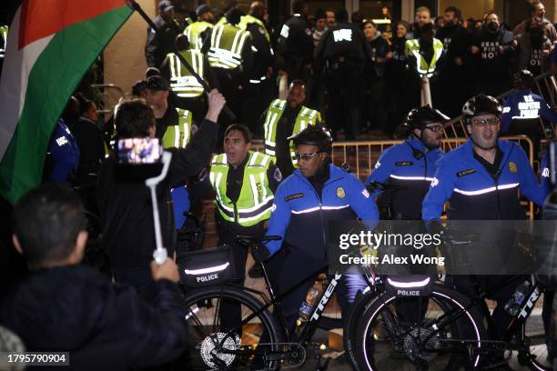 Members of U.S. Capitol Police try set up a perimeter with their bicycles as protesters block the entrance of the headquarters of the Democratic...