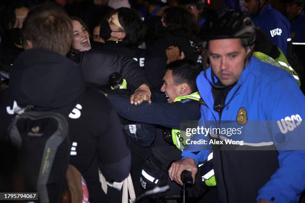 Members of U.S. Capitol Police pull protesters away from the headquarters of the Democratic National Committee during a demonstration against the war...