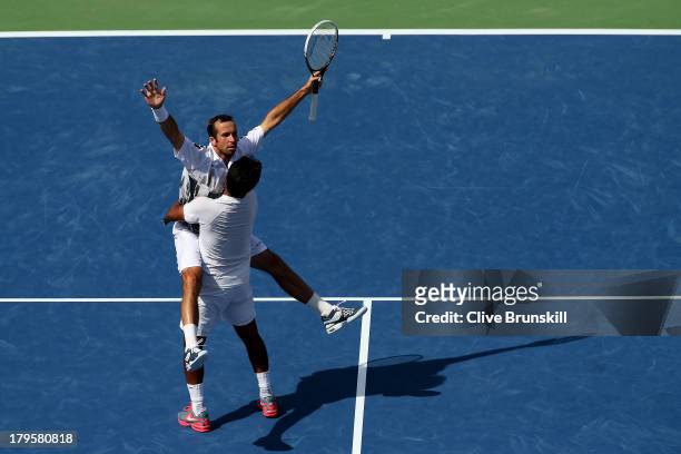 Radek Stepanek of Czech Republic and Leander Paes of India celebrate match point during their men's doubles semi-final match against Bob Bryan and...