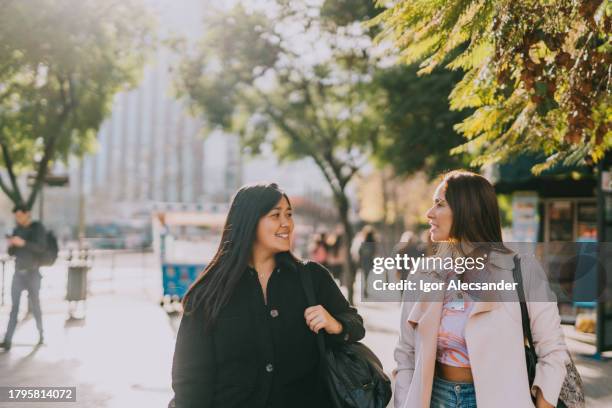 women friends on their way to work in the city - santiago chile stock pictures, royalty-free photos & images