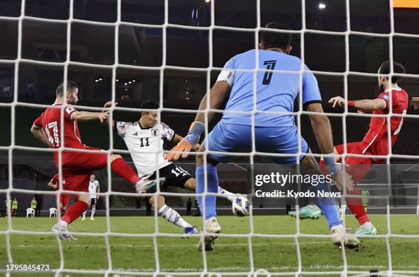 Japan's Mao Hosoya scores a goal against Syria during the late half of an Asian second-round qualifying match for the 2026 football World Cup in...