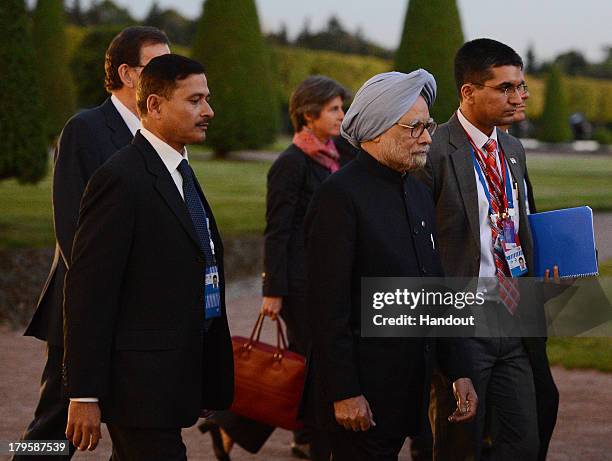 In this handout image provided by Host Photo Agency, Indian Prime Minister Manmohan Singh walks after the first day of the G20 Summit on September 5,...