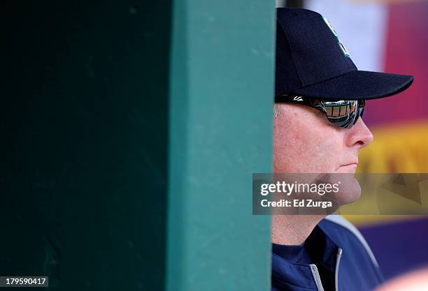 Manager Eric Wedge of the Seattle Mariners looks out from the dugout prior to a game against the Kansas City Royals at Kauffman Stadium on September...