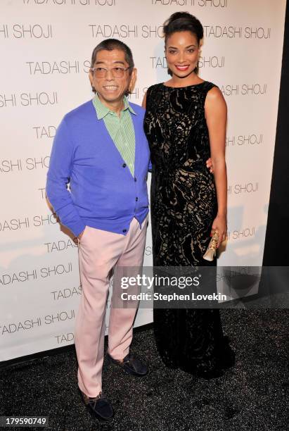 Designer Tadashi Shoji and actress Rochelle Aytes prepare backstage at the Tadashi Shoji Spring 2014 fashion show during Mercedes-Benz Fashion Week...