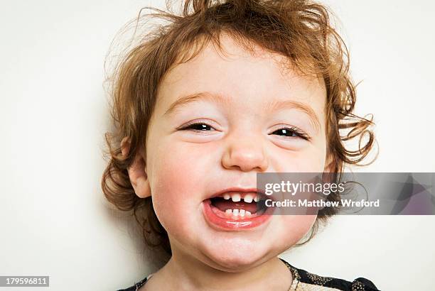 Little girl laughing with gappy teeth.