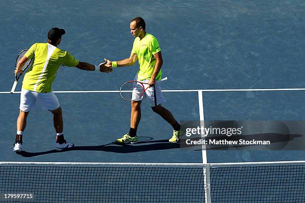 Bruno Soares of Brazil taps hands with his partner Alexander Peya of Austria during their men's doubles semifinal match against Ivan Dodig of Croatia...